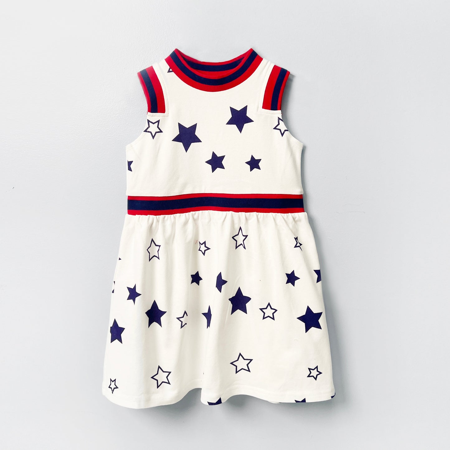girls white dress, star print girls dress, patriotic summer outfit, toddler dress with stars, sleeveless girls cotton dress, red white blue dress girl, kids summer party outfit, breathable girls twirl dress, trendy 4th of July kids fashion, girls dress with striped trim